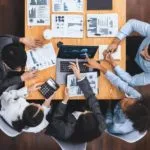 Team of professionals analysing graphs and data in a business meeting