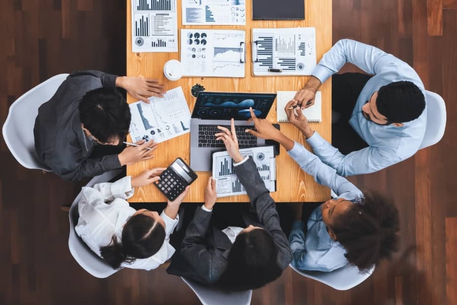 Team of professionals analysing graphs and data in a business meeting