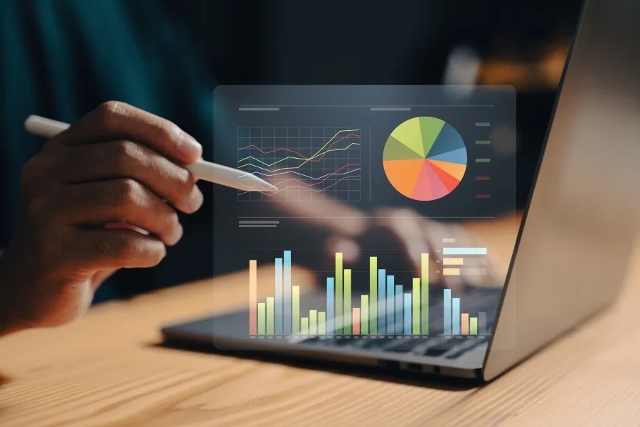 a stylised image of floating metrics next to a laptop