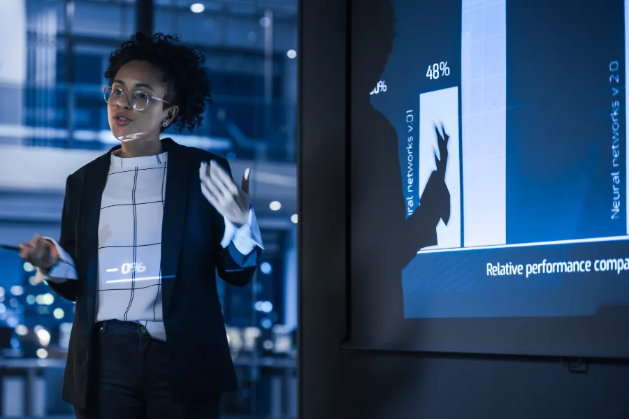 a sales coach presents stats to her field force