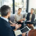 a group of people carry out feedback on sales coaching