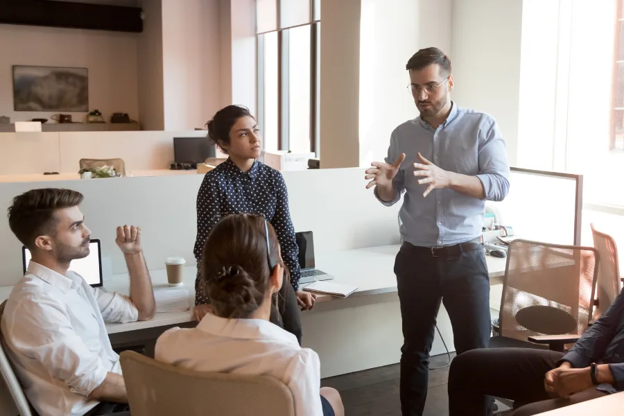 a meeting of sales teams being coached