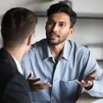 Two men discuss the GROW coaching model